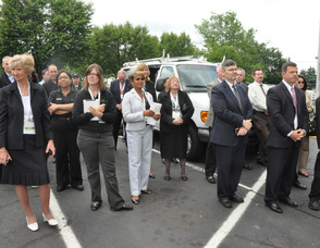 Employees listen to Spires at the grand reopening.