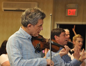 Georgian Banov plays the violin along with Living Waters Fellowship's Worship Team.