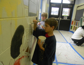 A student painting the mural