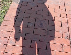 Self-portrait shadow photograph of Joel Aronson while saluting US Military symbols at the Memorial Park in Wharton, NJ. The photo was taken Veterans Day 2011, 11/11/11 at 11:11 AM. Joel is a veteran of the US AIr Force.