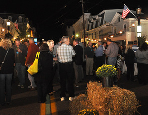 Attendees mingle and eat on Spring Street.