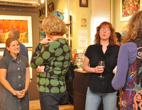 Jennie Traill Schaffer, owner of TraillWorks, mingles with exhibit attendees.