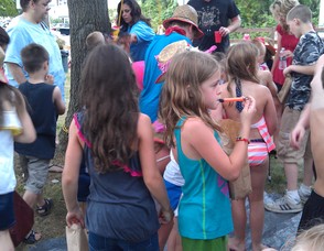 Children play music after busting open the piñata.
