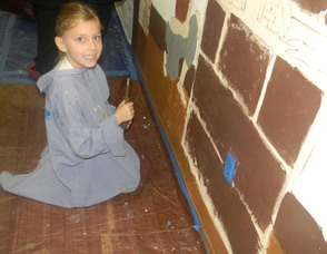 A student painting the mural