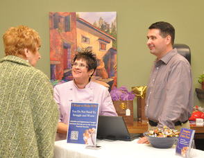 Gregg Boonstra of Vertical Vision and Jewels Quelly of Angel Food speak with one of the guests.
