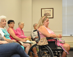 Employees and volunteers for the Sussex County Homestead sit and listen for the results.