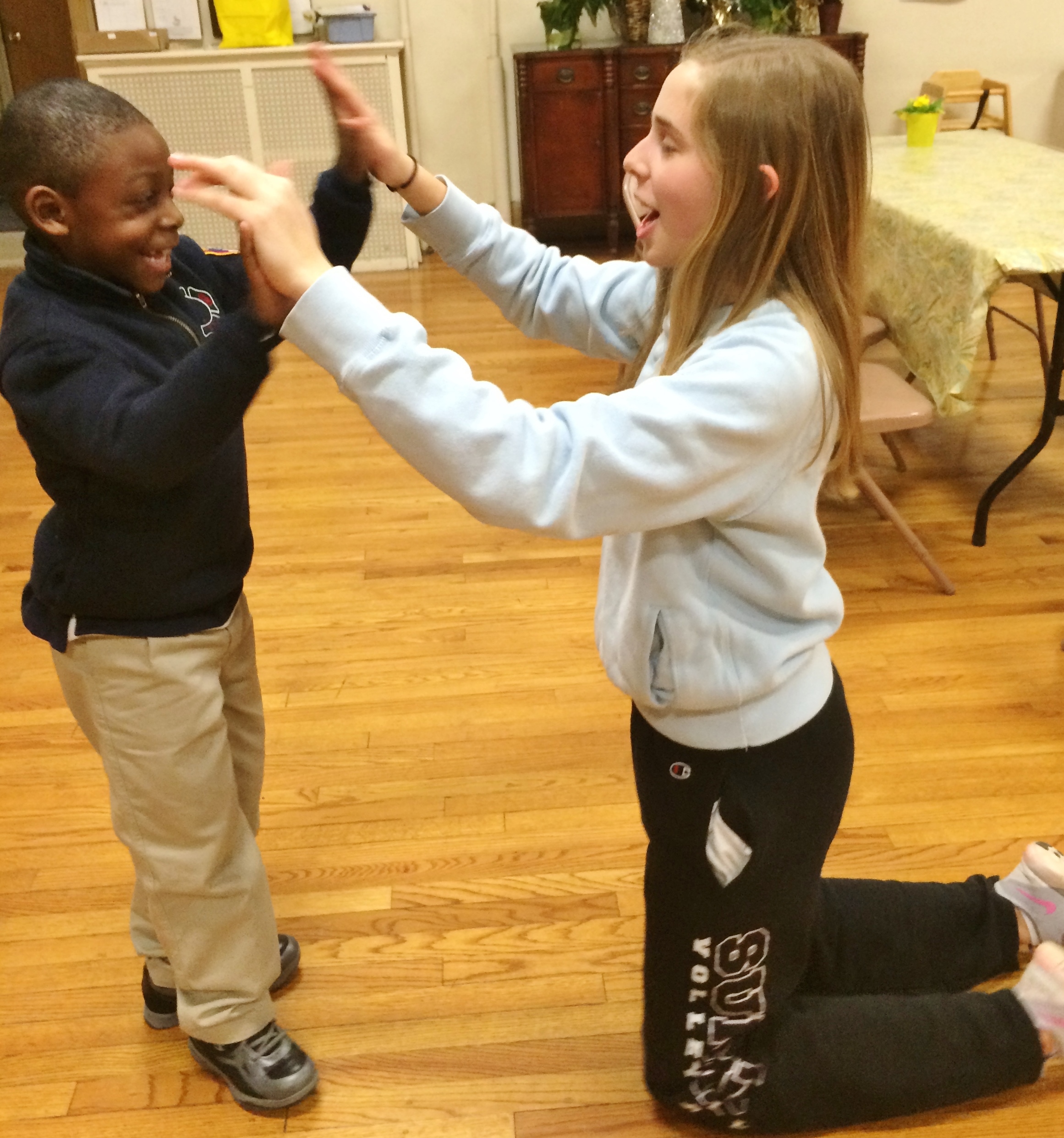 973fedacc891ed3debc9_Volunteer_and_boy_hands_-_Copy.jpg