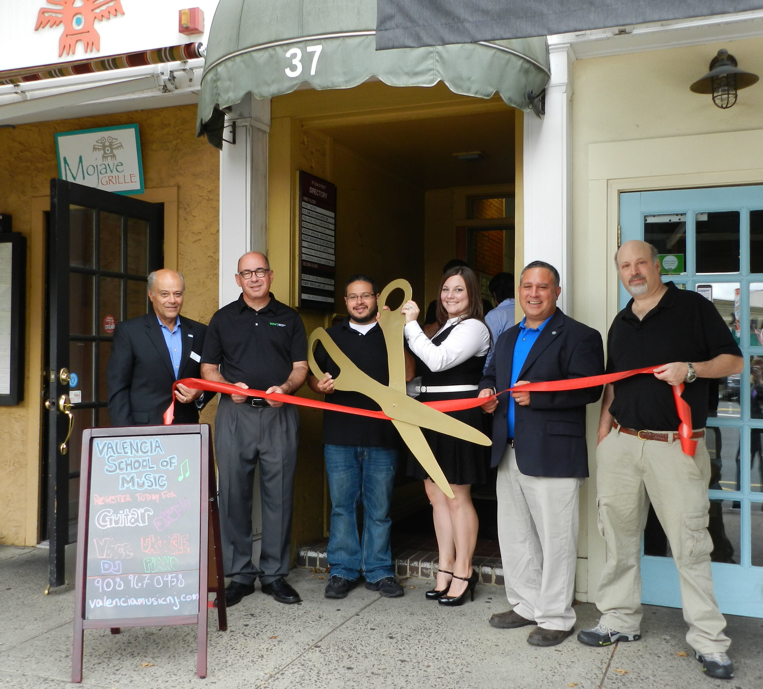 f8c9cd0a62f97a5cba75_d25ea87af40491c54fbf_Valencia_Ribbon_Cutting.jpg