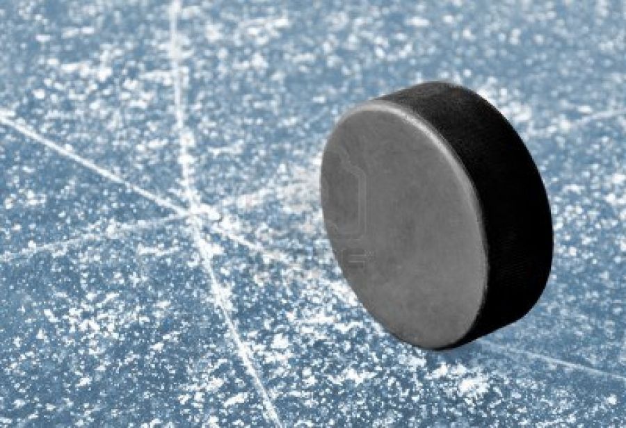 4c0537b7e639f3579d05_3446_black_hockey_puck_on_ice_rink.jpg