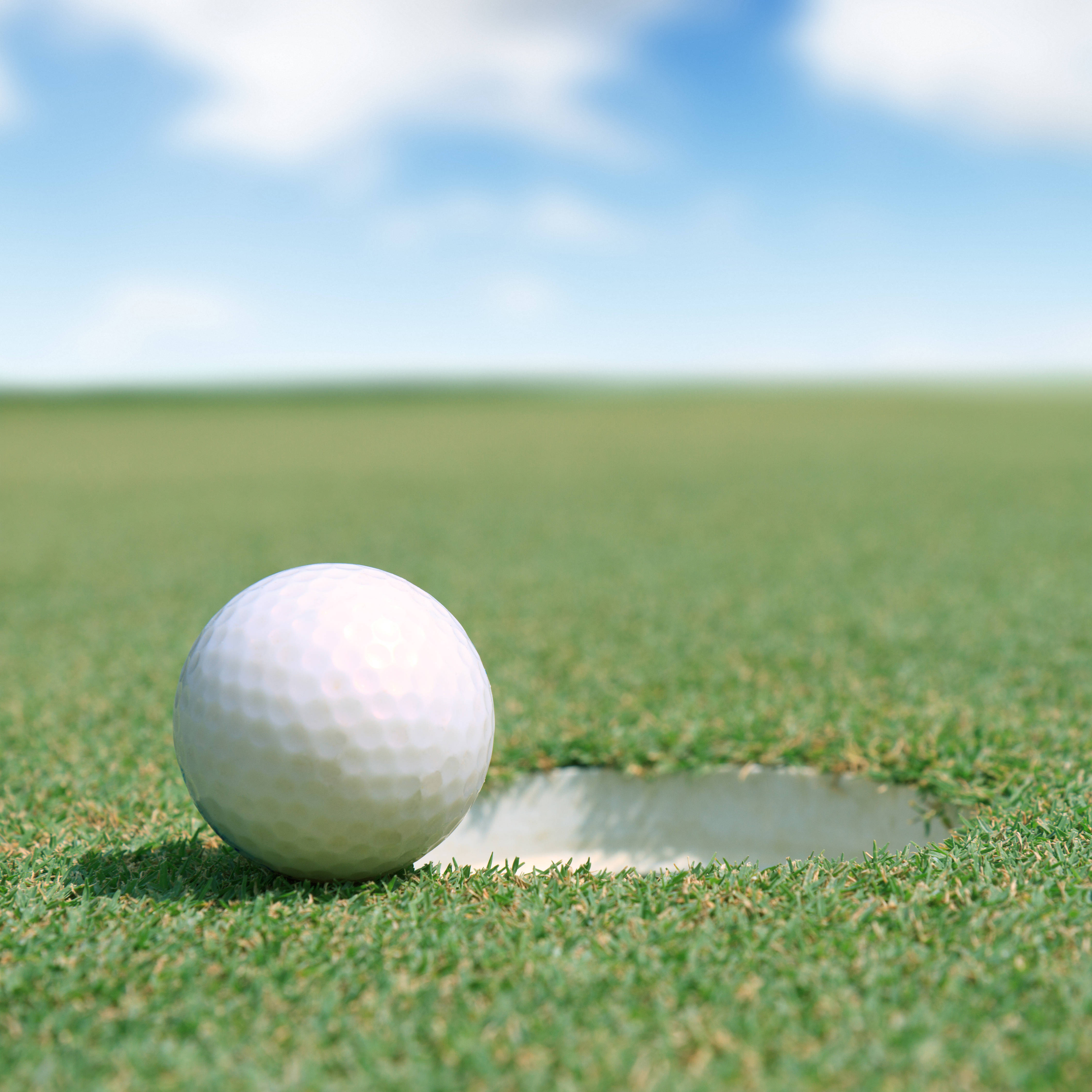 02a36cebd31f3eb6bf6b_Golf_ball_at_hole_photo.jpg