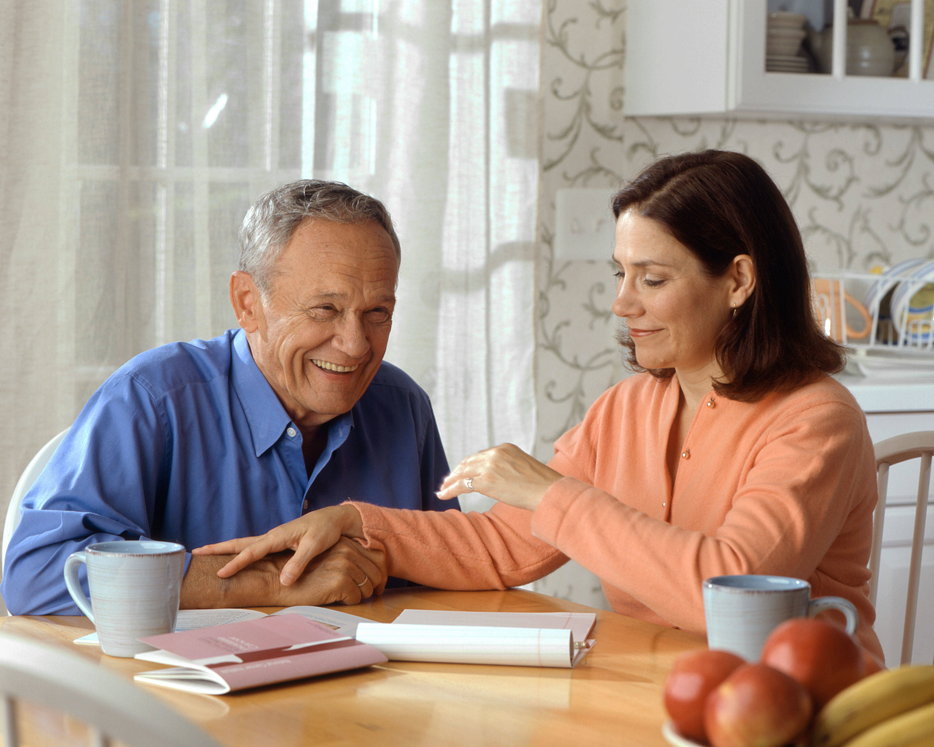 1a678d883ce511f78be2_Couple_sitting_at_a_kitchen_table__2_.jpg