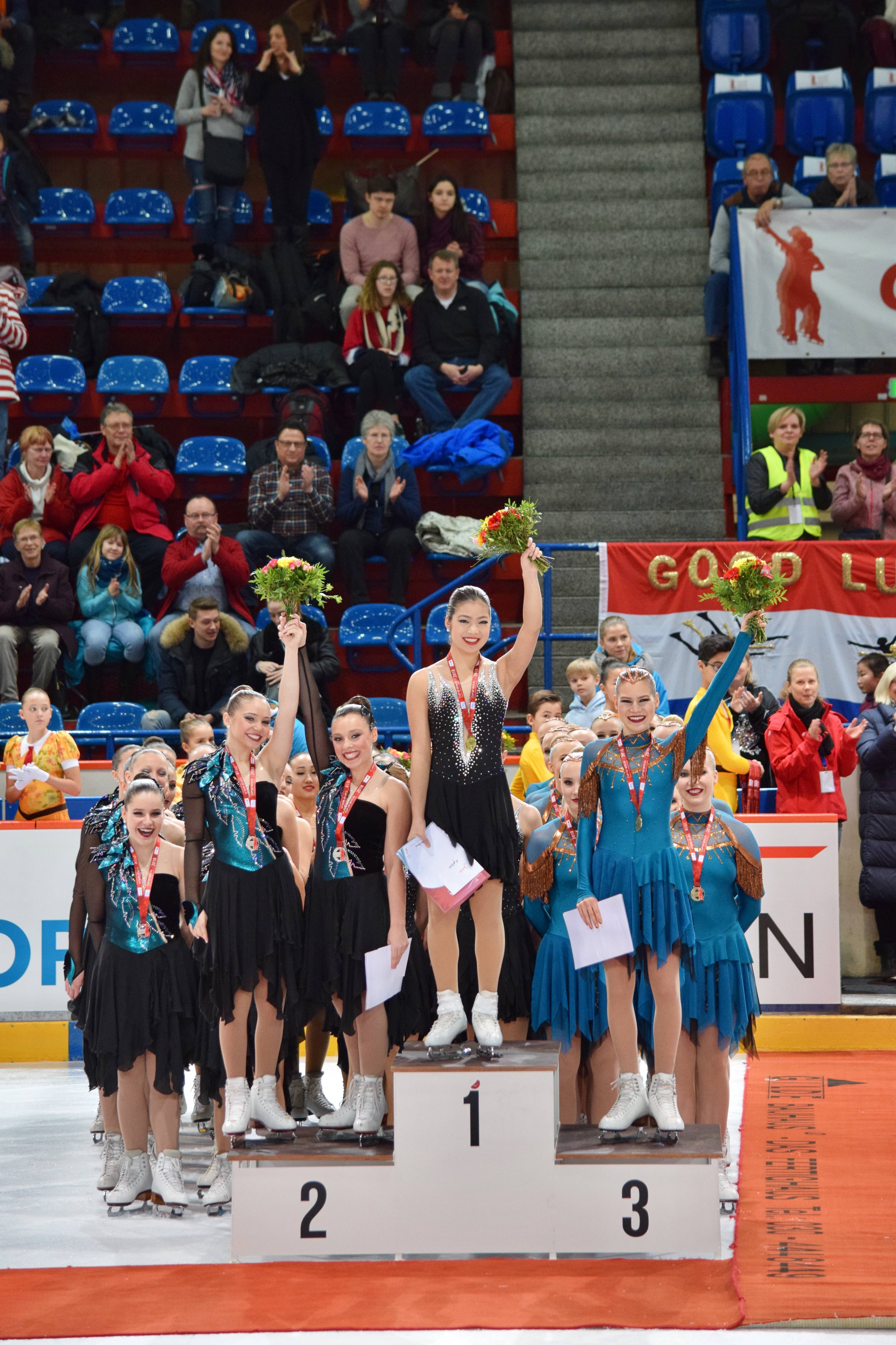 5d422a47b470a4f5c6e3_2c790260280dbd1f33c0_Audrey_Laude_on_Podium.jpg