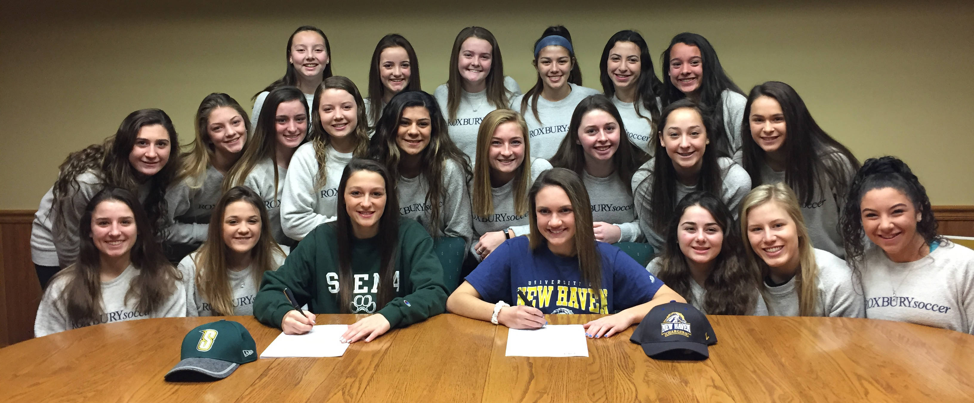 6a92e97148cee031091a_Sarafin_and_Sansone_Sign_with_Teammates.jpg