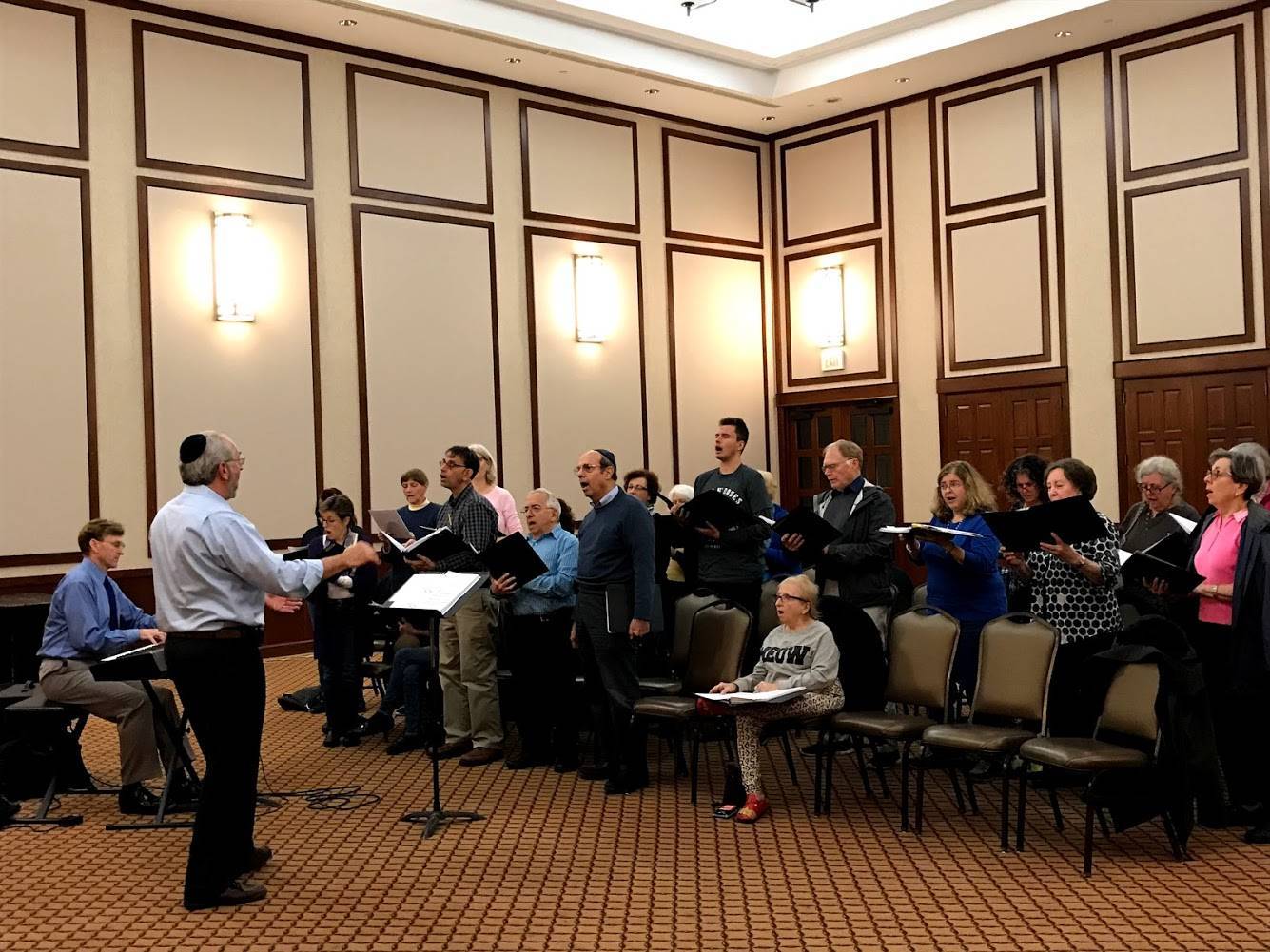 87553a14a9498e507f09_Cantor_Perry_Fine_leading_a_rehearsal_of_the_Voices_of_Harmony_Interfaith_Chorus.jpg