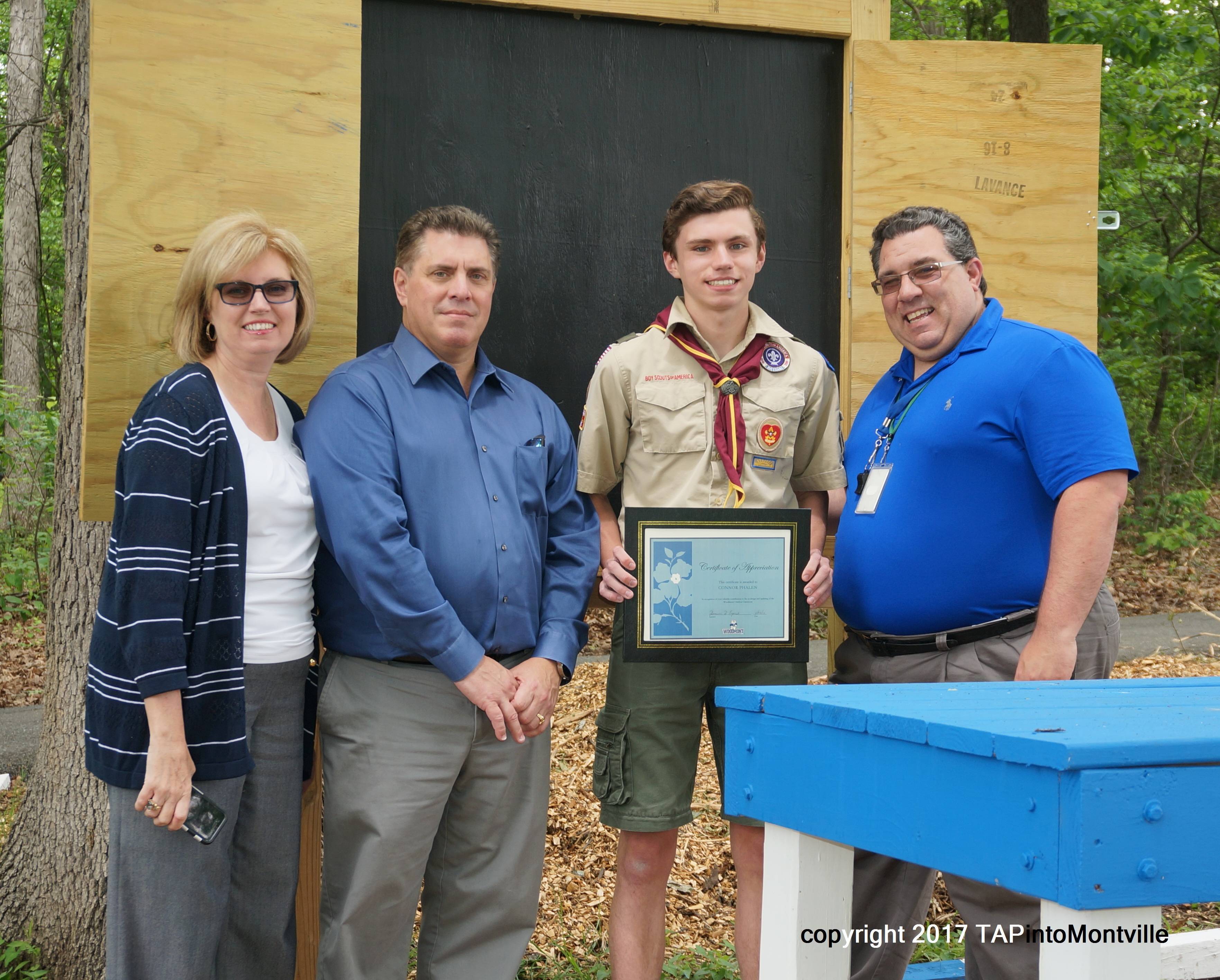 beb5973605b99267870b_a_Parents_Doreen_and_Patrick_Phalen__Scout_Conner_Phalen__and_Woodmont_Principal_Dominic_Esposito.jpg
