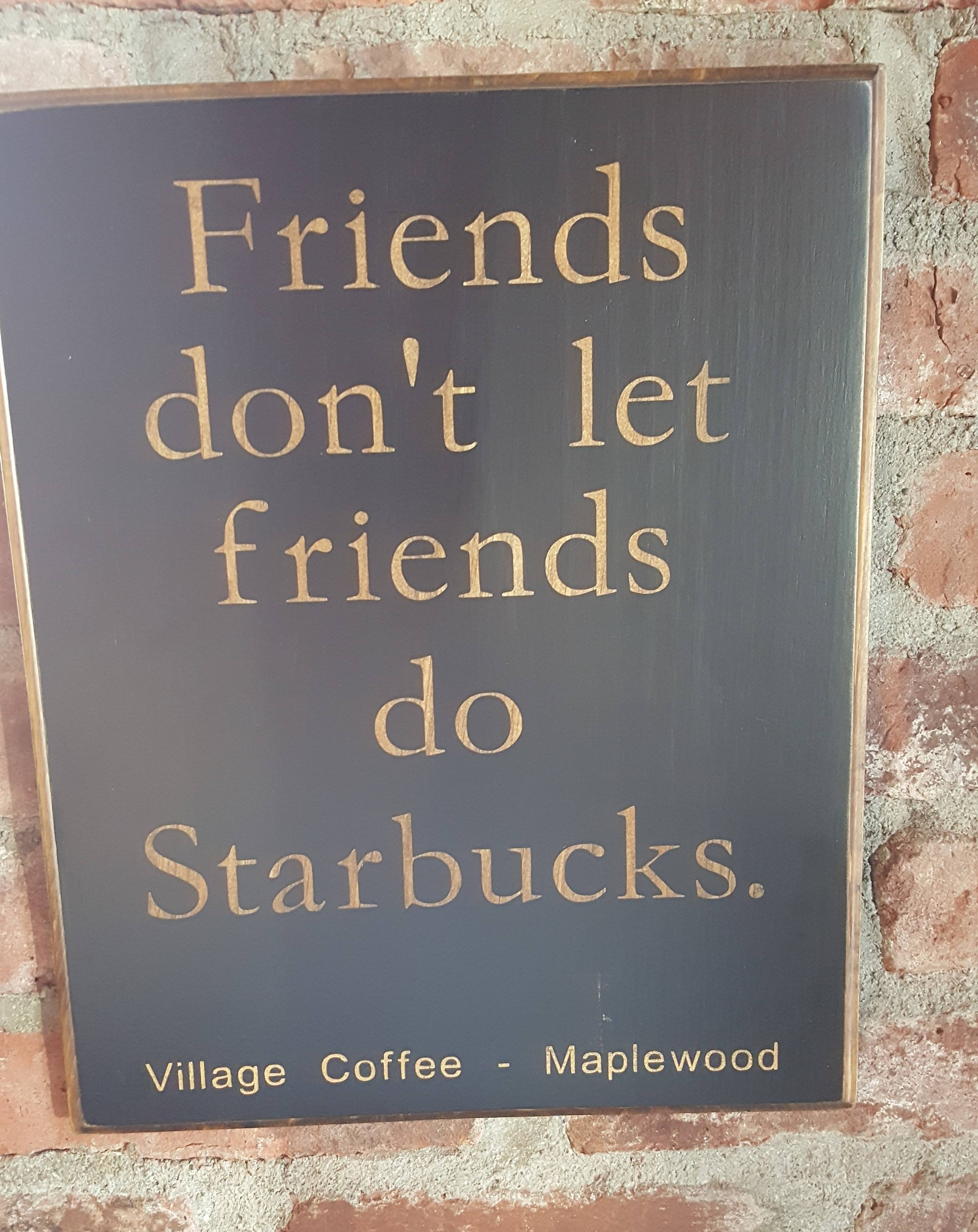 da2adad44cac6b68c771_starbucks_sign_village_coffee.jpg