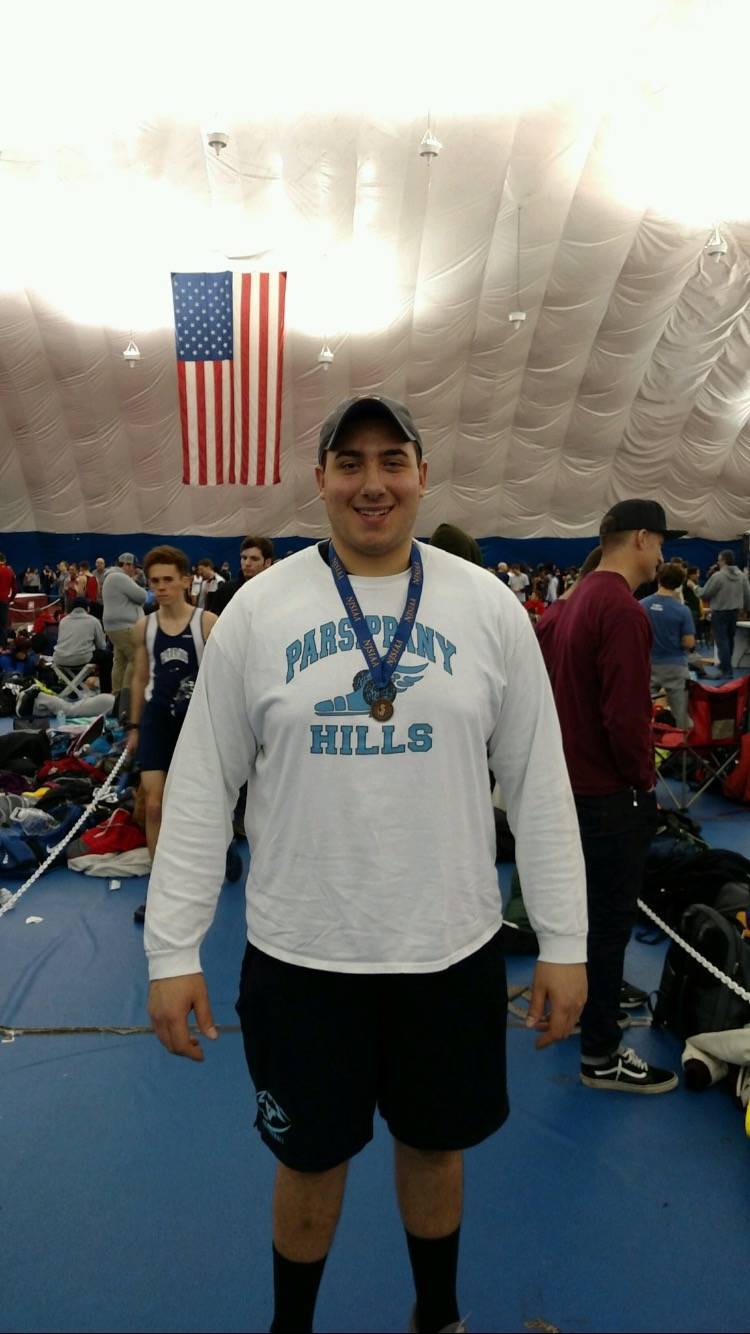 dcfd8903822d091e0f3d_Justin_Gurth_displays_the_medal_he_won_for_finising_third_at_the_Group_4_indoor_meet.jpeg