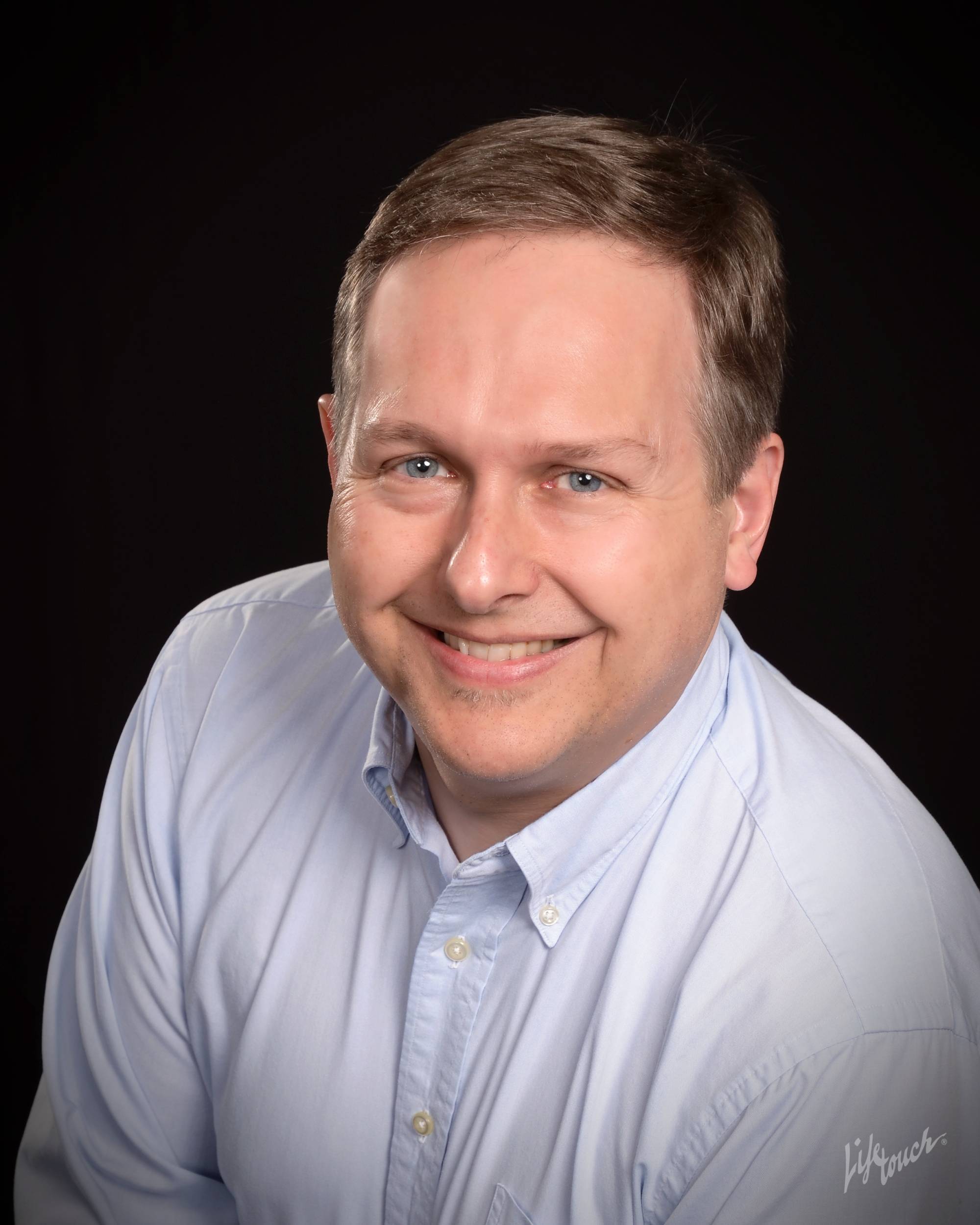 e2ab4ea1ad30b0f19e13_tom_kamp_head_shot.jpg