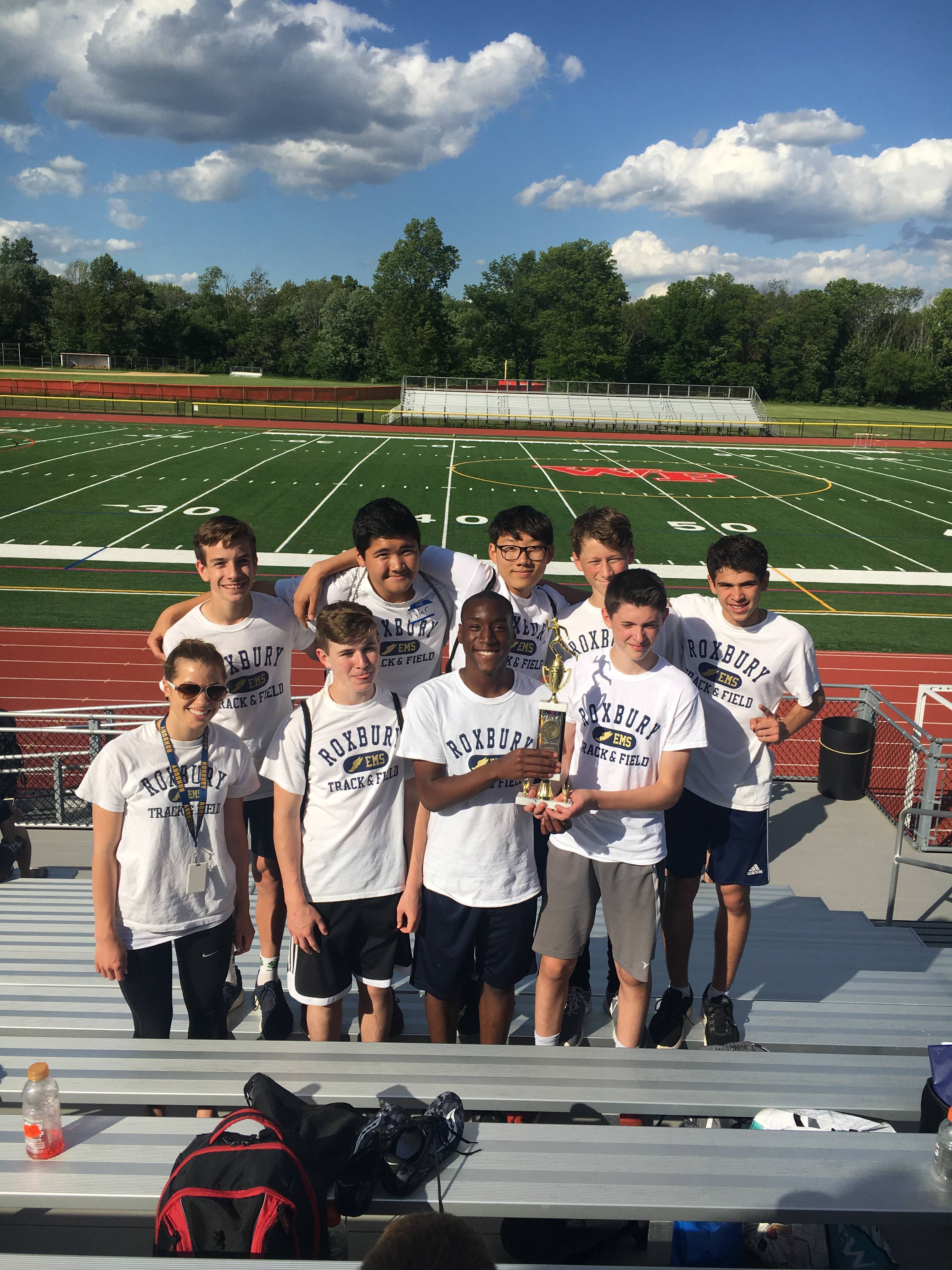 e2d8052a42206d6ed596_a2fabf447946a7904822_EMS_Track_Team_with_Trophy.jpg