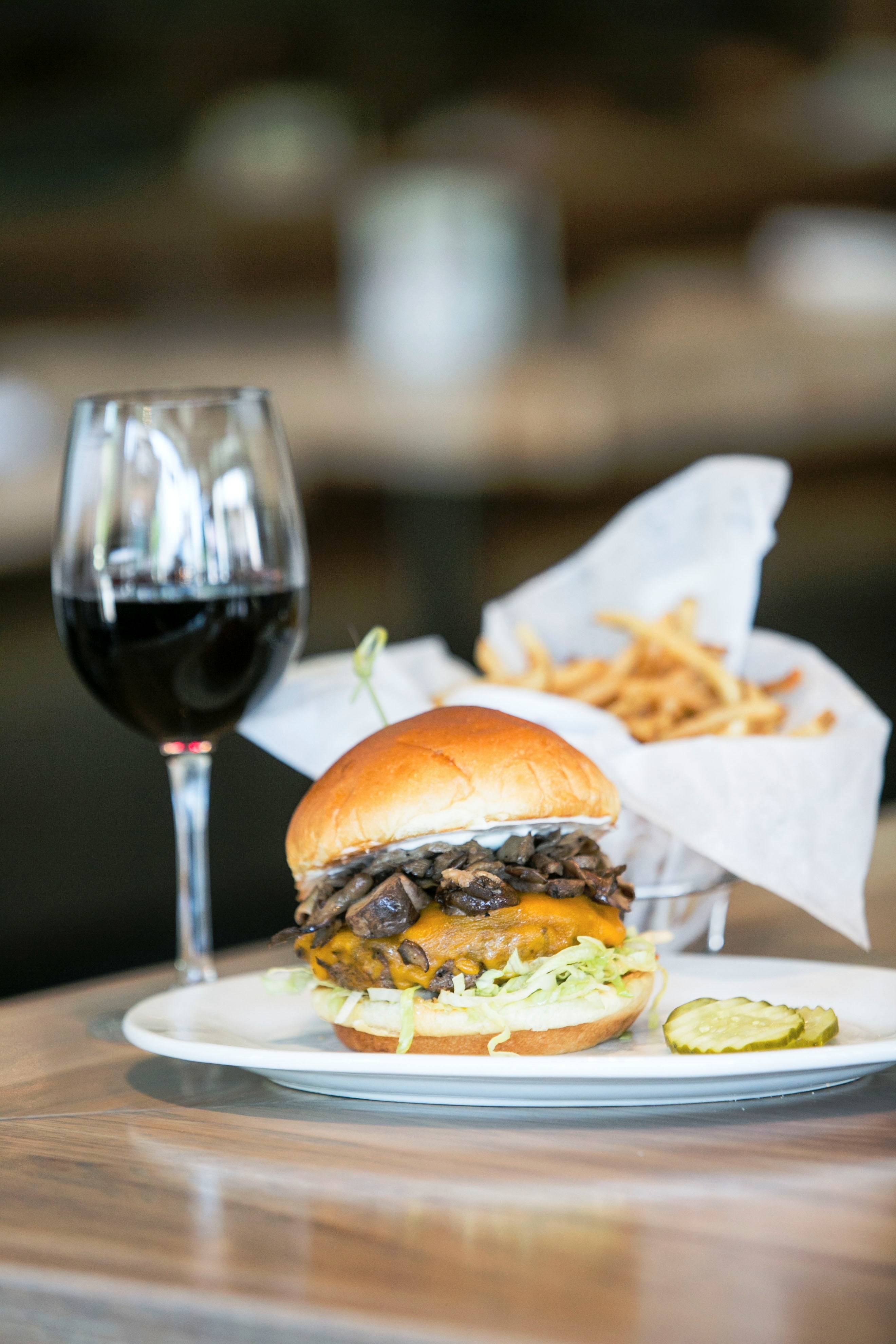 f462fecd8a4b56704eba_Zinburger_-_Kobe_Burger_With_Wine_Glass.jpg