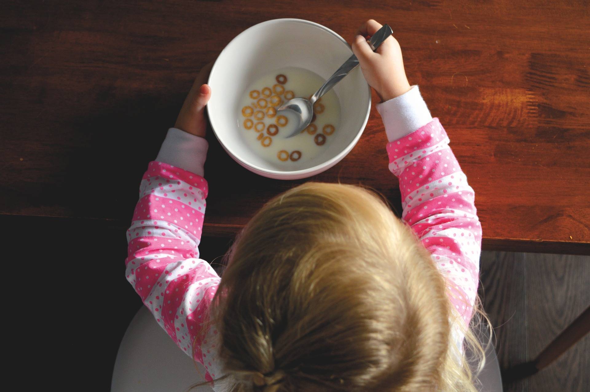 fe47d04ebc2c4b2701a3_child_food_bank_eating_cheerios.jpg