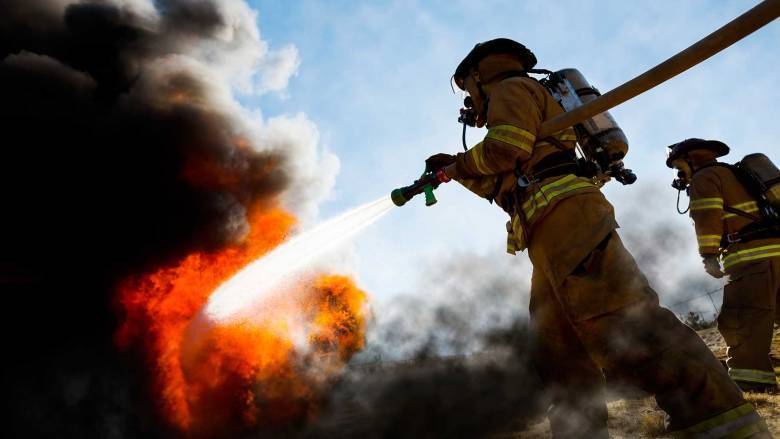 ffc38c876eb37a84e767_firefighter-carrying-hose.jpg