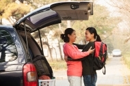 a3329b643b2b72318a15_stock-photo-28700406-mother-and-daughter-embracing-behind-car-on-college-campus.jpg
